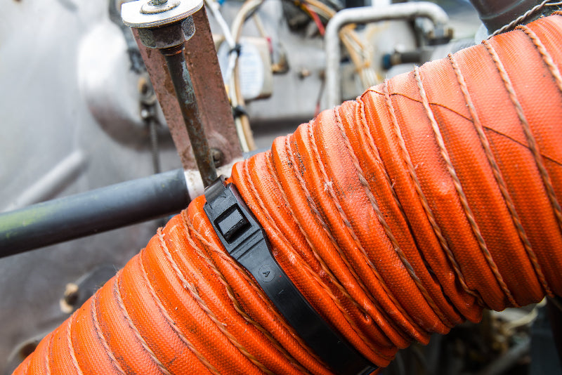 Cobra low profile black zip tie being used to secure a hose cleaner and safer than traditional ties